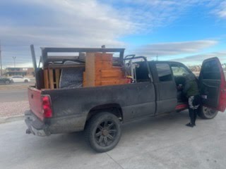 Junk removal workers loading truck in Colorado Springs